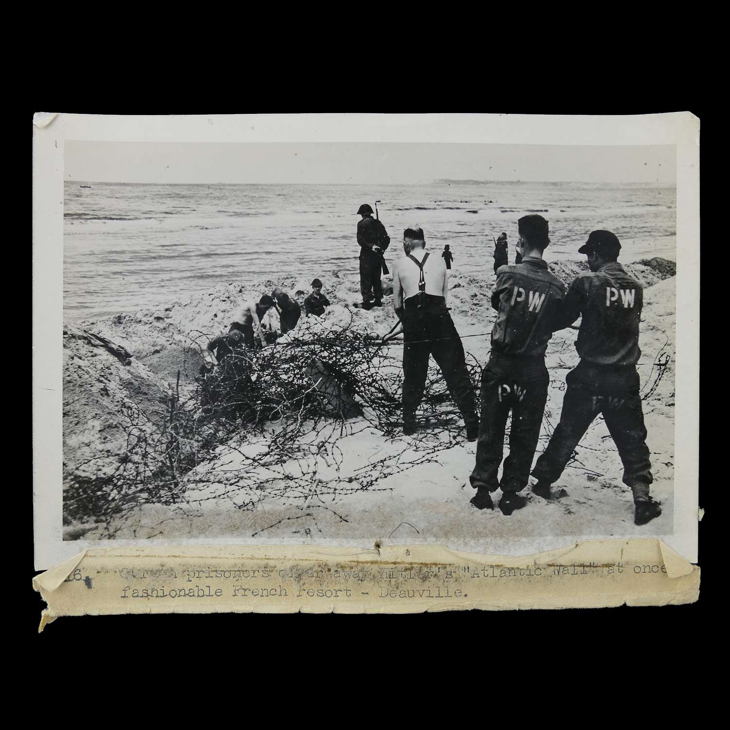 Press photograph - German PoWs clearing French beaches